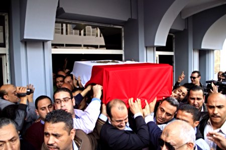 The body of slain Police Brigadier General Tariq al-Mirjawi is carried out of the Agouza Police Hospital after a series of explosions hit Cairo University - Cairo 2-Apr-2012