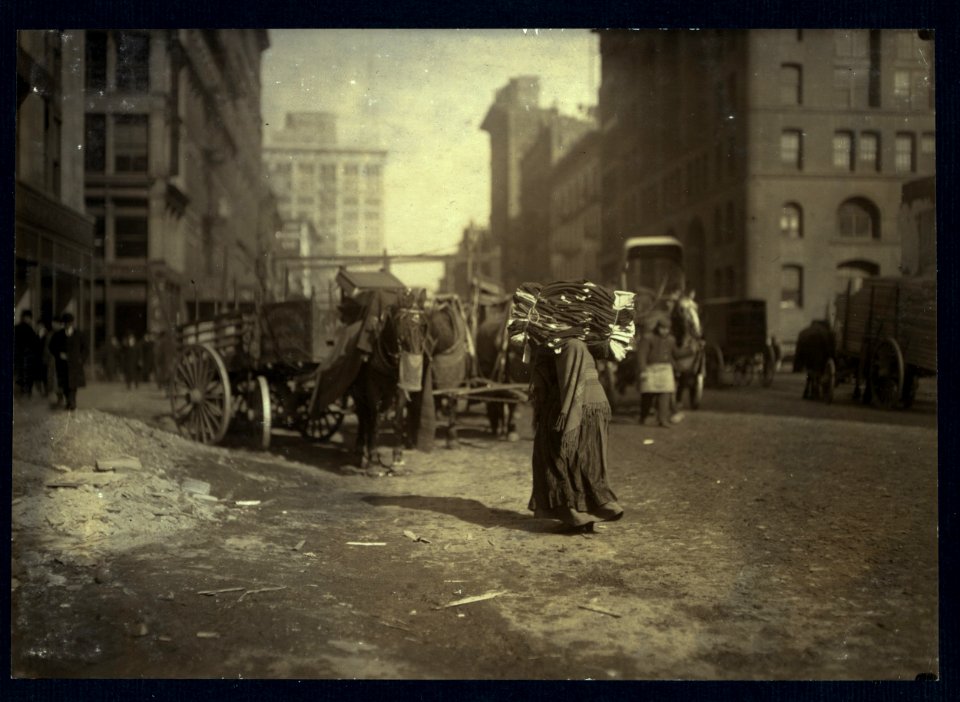 The breaking point. A heavy load for an old woman. Lafayette St., below Astor Pl., N.Y. LOC nclc.04165