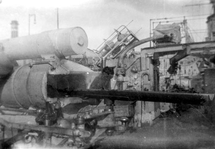 The breech of after port side four-inch gun on HMS 'Aurora (1913) while in drydock. RMG N22868