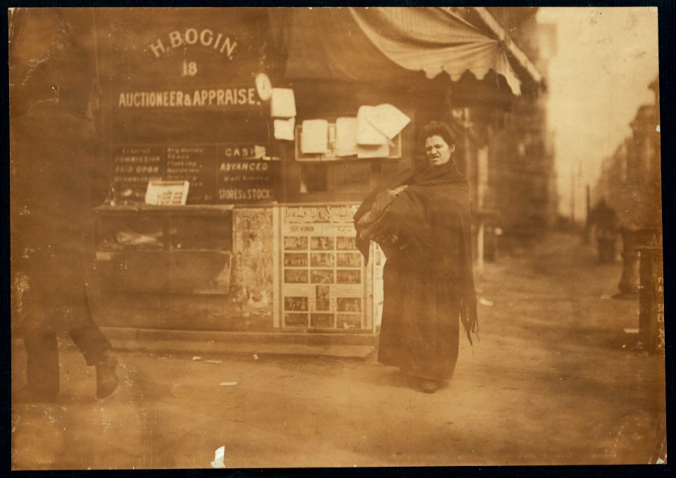 The bundles of clothing are often much heavier than they appear. (See her face.) East Side, N.Y. LOC nclc.04156