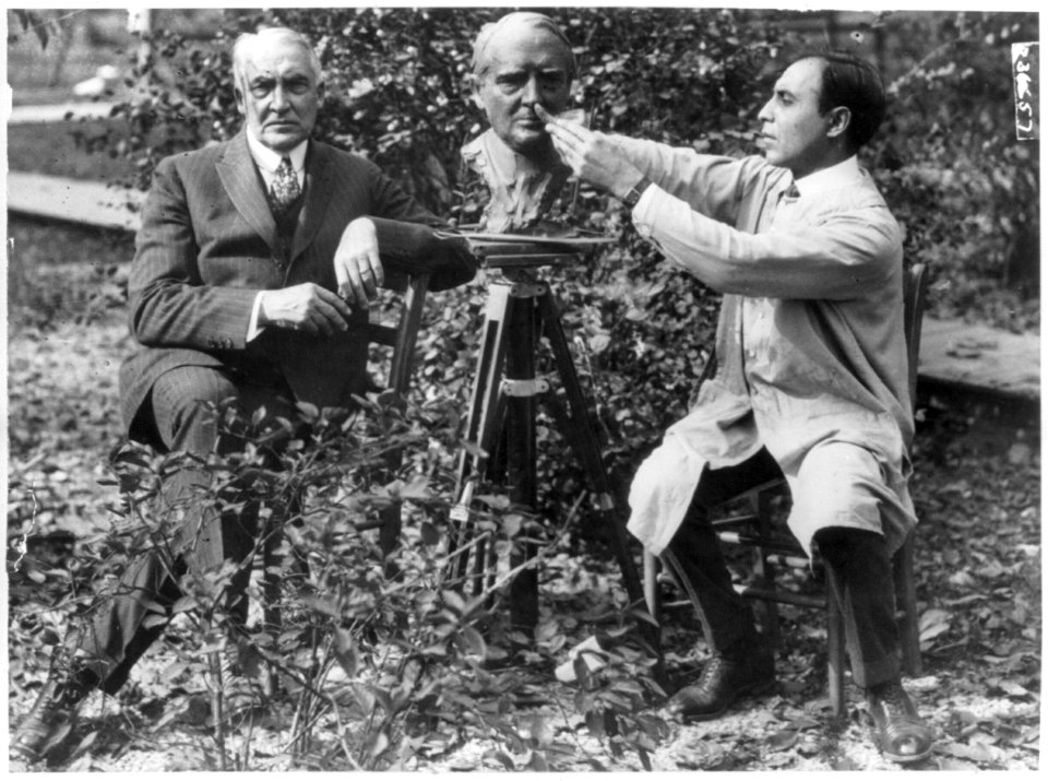 Senator Warren G. Harding, Republican nominee for President, posing in the shade of his front porch at Marion, Ohio for Louis Keila, noted sculptor LCCN2003654862