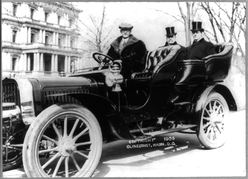 Senators Albert J. Beveridge and Albert Jarvis Hopkins in the back seat of a chauffeured automobile, with State, War and Navy building in background LCCN2005680250