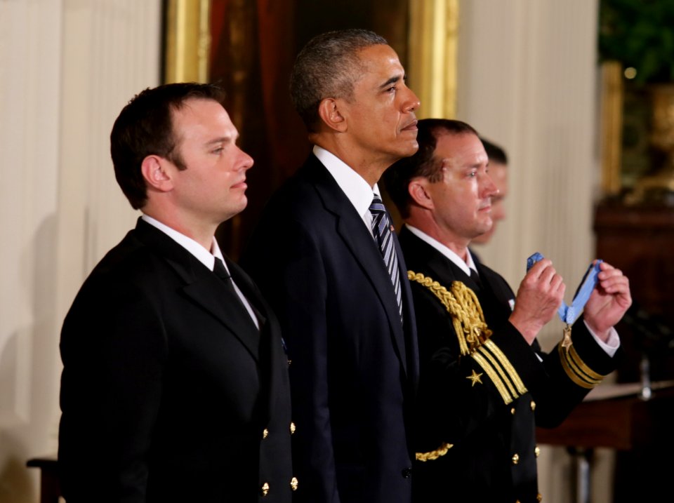 Senior Chief Special Warfare Operator (SEAL) Edward C. Byers Jr., left, and President Barack Obama listen as the award citation is read during a Medal of Honor ceremony (24756817863)