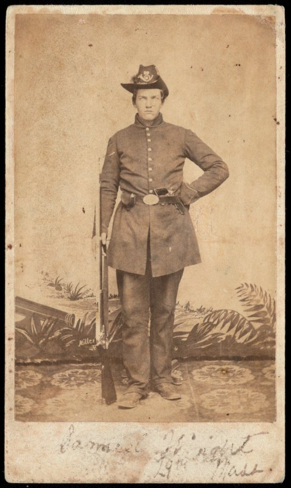 Sergeant Samuel Cole Wright of Co. E, 29th Massachusetts Infantry Regiment, standing in uniform with revolver and musket in front of painted backdrop) - Union Photographic Gallery, Camp LCCN2017659677