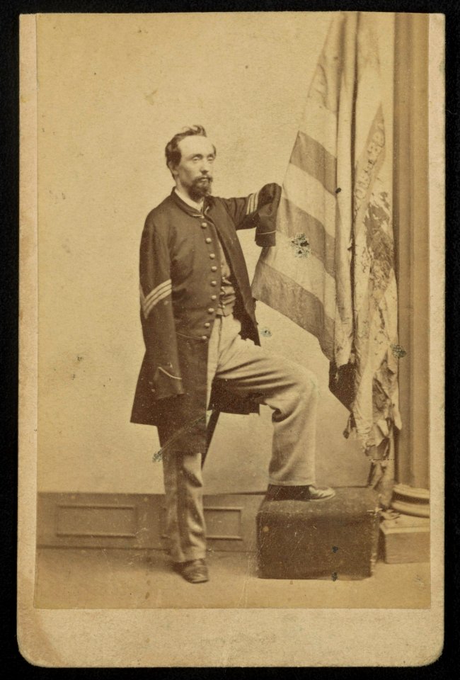 Sergeant Thomas Plunkett of Co. E, 21st Massachusetts Infantry Regiment in uniform with American flag) - J.W. Black, 173 Washington St., Boston LCCN2016652139