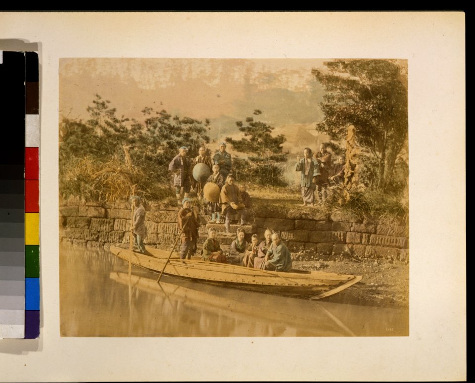 Several people posed for a portrait in a ferry and standing on the banks of a river at the terminal LCCN2009632887
