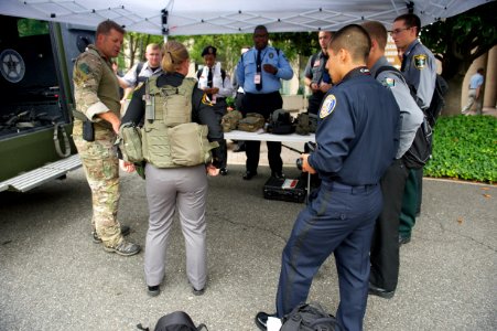 Several law enforcement explorers examine tactical gear
