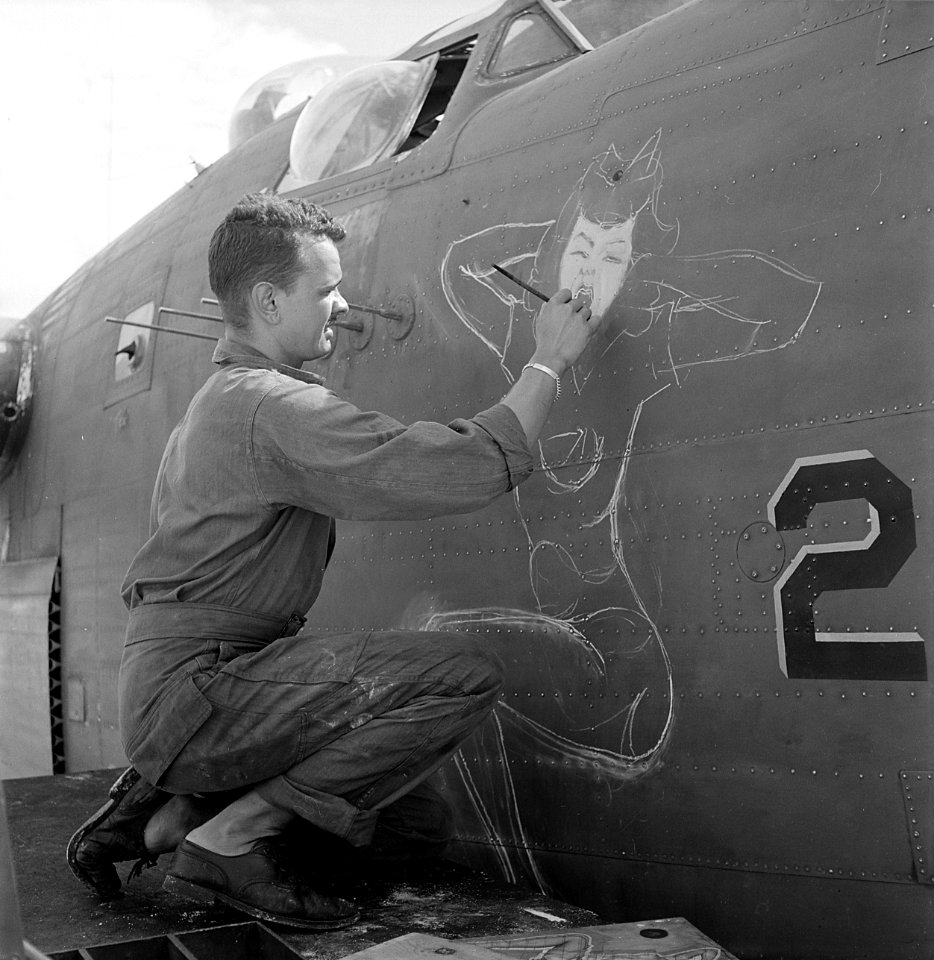 Sgt. J.S. Wilson, USA, painting a design of prow of a bomber based at Eniwetok. - NARA - 520724