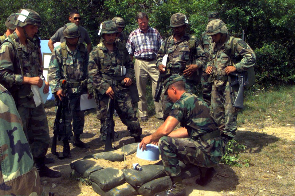 SGT Lance G. Halston demonstrates the proper way to place a land mine to U.S. Senator James Inhofe