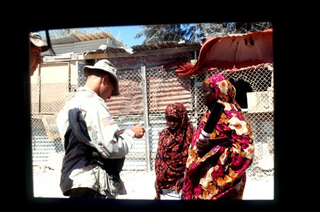 SGT. James King, 10th Military Police Company, US Army, checks the identification of two Somalian women at the Mogadishu airport DF-ST-96-01070