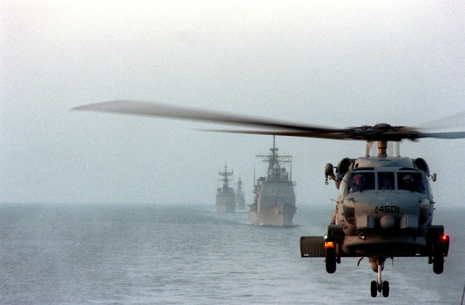 SH-60B Seahawk flying in front of USS Saratoga (CV-60) battle group in Mediterranean September 1987 DN-SC-88-05512