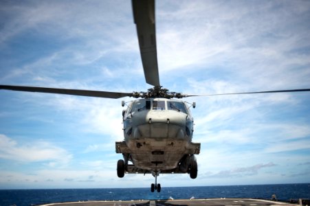 SH-60 Seahawk helicopter approaches flight deck of USS Cowpens 120704-N-TX154-038