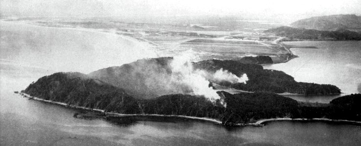Shells from USS Saint Paul (CA-73) hit North Korean positions at Wonsan, Korea, circa in December 1950 photo