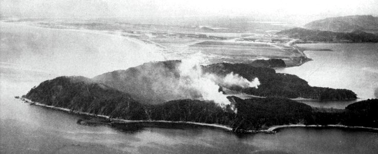 Shells from USS Saint Paul (CA-73) hit North Korean positions at Wonsan, Korea, circa in December 1950