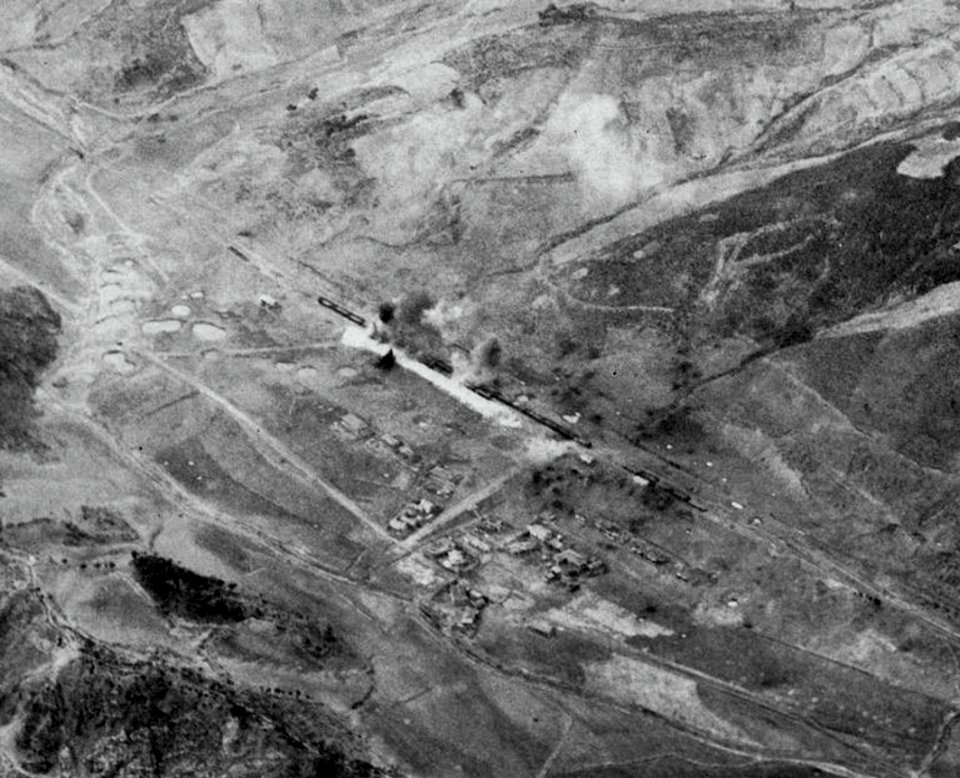 Shells from USS Saint Paul (CA-73) hit a railway station in Korea, circa in late 1950
