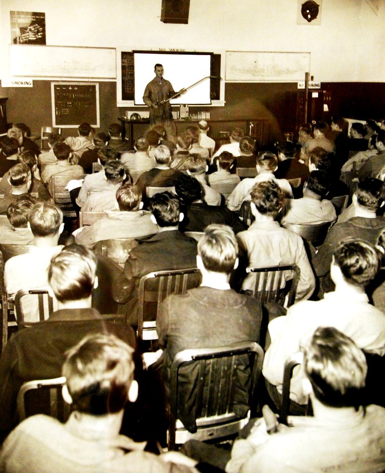 Ship fire fighting class, Fireman First Class George Gruber teaching use of spray nozzle (25839098633)