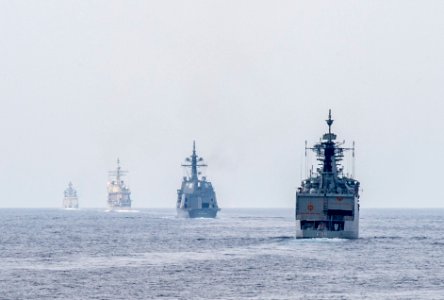 Ships from the Indian Navy, Japan Maritime Self Defense Force and U.S. Navy get into formation for a gunnery live-fire exercise as part of Malabar 2015