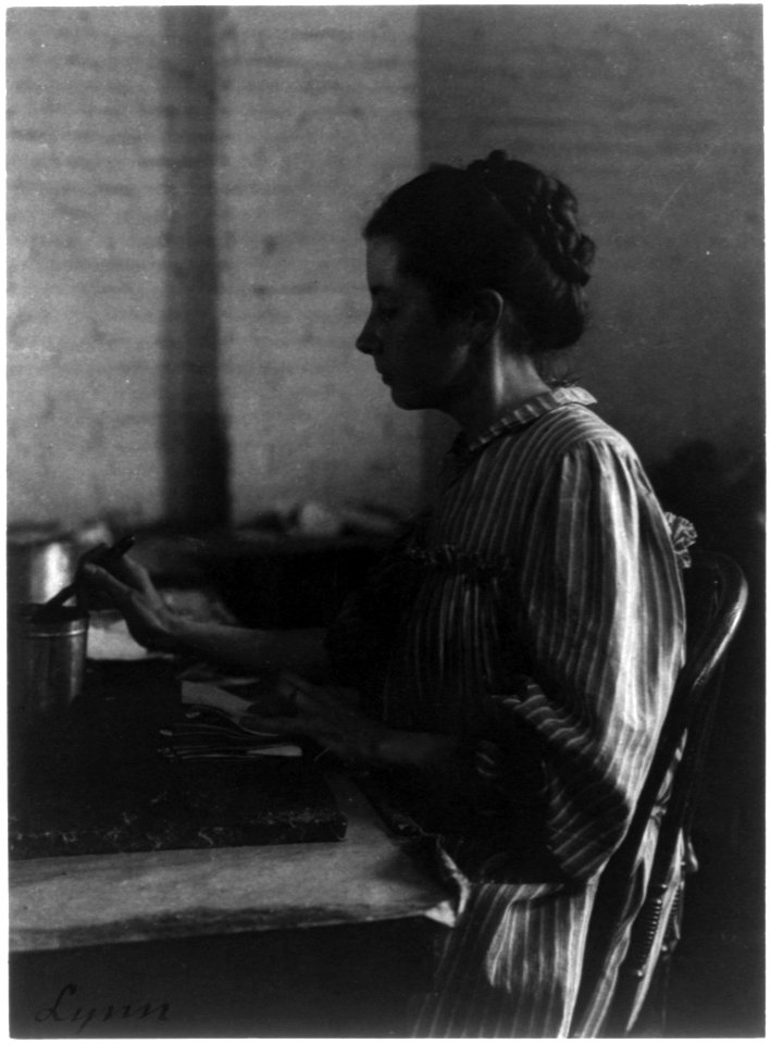 Shoe factories, Lynn, Mass.- woman seated at table, working in shoe factory LCCN2006681285