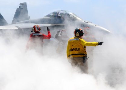 Shooter directs an F A-18F aboard USS Nimitz. (8636663375)