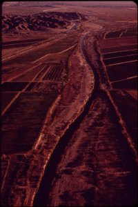 Shrunken-colorado-river-winds-between-onetime-flood-banks-this-is-all-thats-left-after-imperial-dam-background-has-diverted-four-fifths-of-the-river-into-the-all-american-canal-may-1972 7006497698 o
