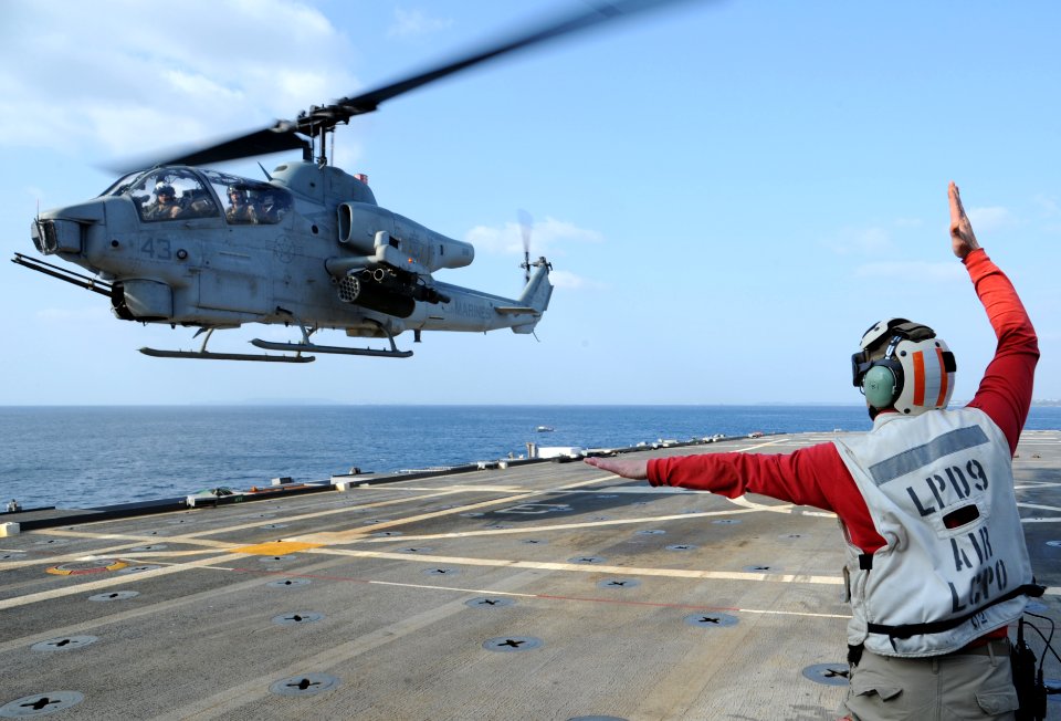 Signaling to the pilot of an AH-1W Cobra helicopter 120404-N-LP801-064