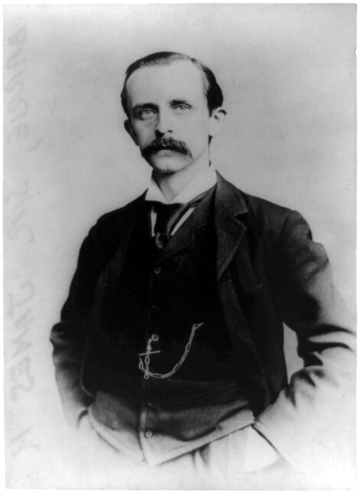 Sir James M. Barrie, author, half-length portrait, standing, facing left, with hands in pockets LCCN97508350