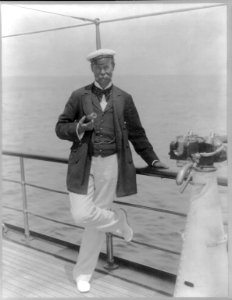 Sir Thomas Lipton, full-length portrait, standing at rail of his yacht, the Erin LCCN2005687140
