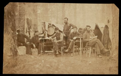 Six Union musicians of the 4th Vermont Infantry Regiment relaxing at camp in a pine forest in Virginia LCCN2014646392