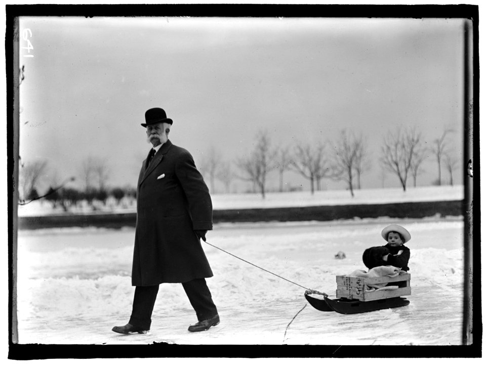 SKATING PARTY. UNIDENTIFIED MAN PULLING CHILD ON SLED LCCN2016863489