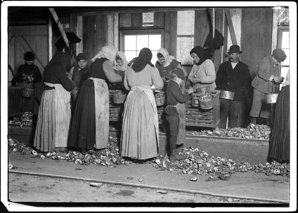 Small boy on the floor is Johnnie Schraker, 8 years old, earns 45 (cents) a day, been at it for 3 years. Note how... - NARA - 523397