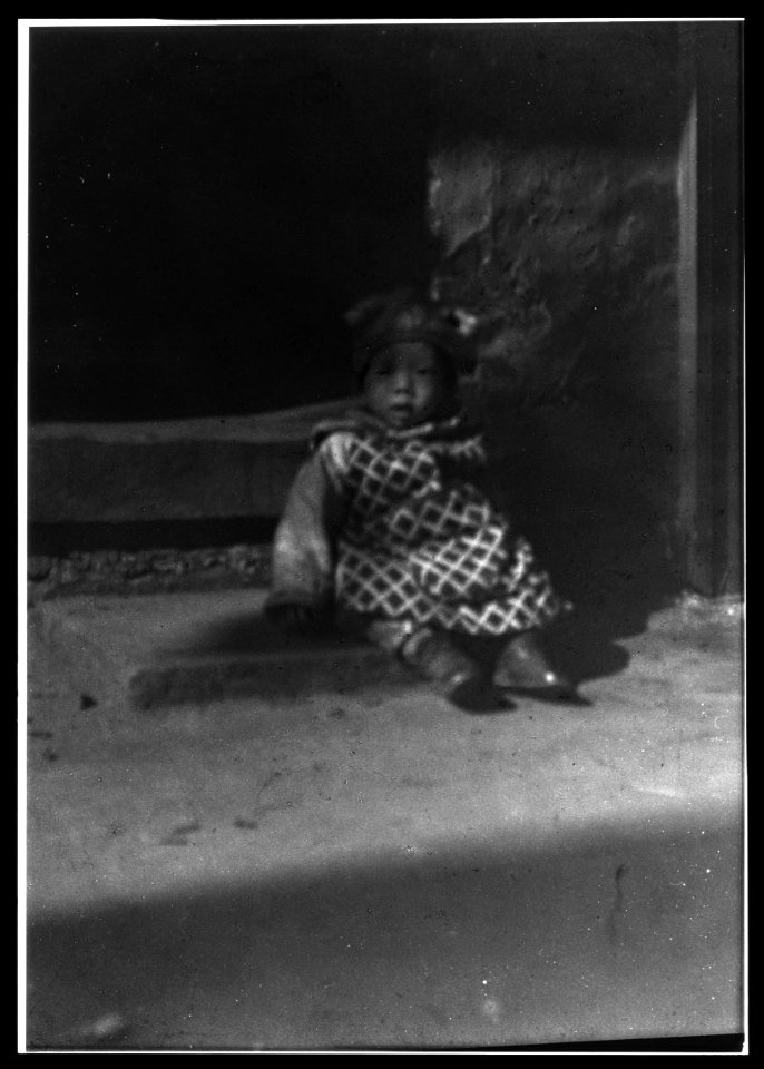 Small child sitting on a doorstep, Chinatown, San Francisco LOC agc.7a55035