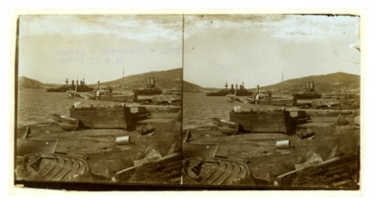 Small boats on shore and warships in harbor; in mid-distance a salvage boat next to a submerged boat, Port Arthur LCCN2005678346