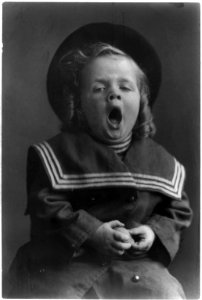 Small boy with long hair wearing hat and sailor coat yawning LCCN2002710331