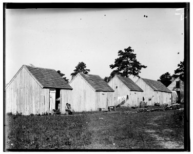 Small shack on Forsythe's Bog, occupied by De Marco family, 10 in the family living in this one room. Room is 10 ft. x 11 ft. x 5 1-2 ft. high and gable attic above. Wooden toilets near at LOC nclc.05310