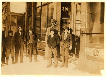 Smallest boy in front of man (in centre of photo) is Jo -- wouldn't give his name, very suspicious. He and the other boys said he is a sweeper in Acushnet Mill; lives at 697 S. Water St. LOC cph.3b46590
