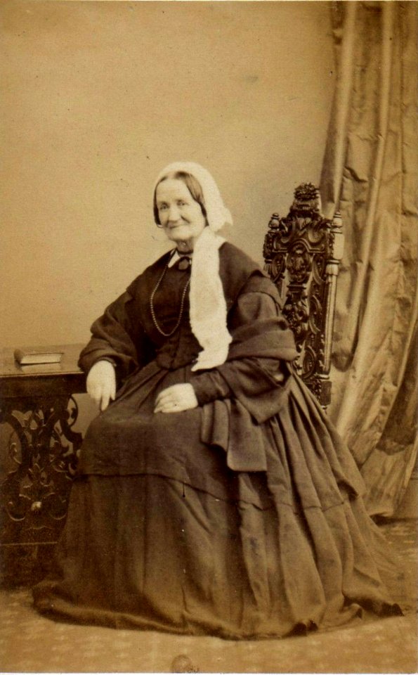 Smiling woman wearing lace cap by T & J Holroyd (1)