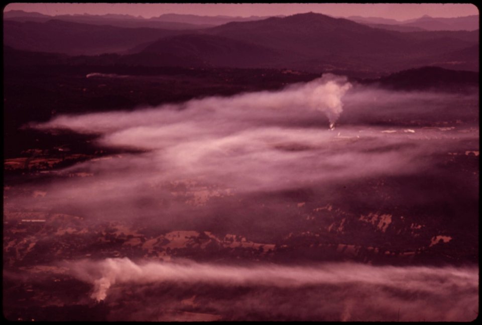 Smoke-from-two-lumbermills-floats-in-early-morning-air-east-of-sonora-california-in-august-1973-this-area-was-ravaged-by-a-major-forest-fire-september-1973 7153155569 o
