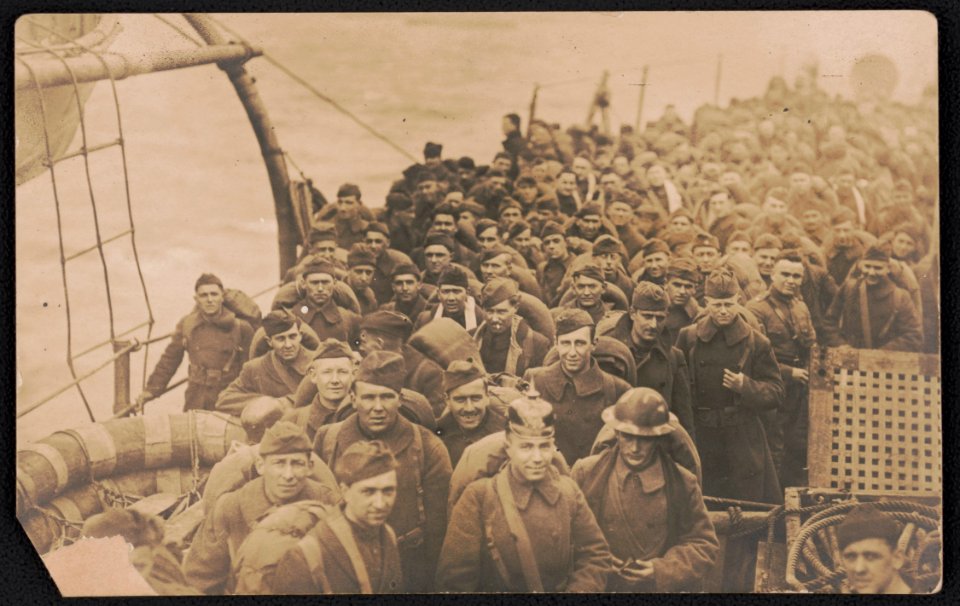 Soldiers returning home from war aboard ship, including one wearing a pickelhaube LCCN2018645949