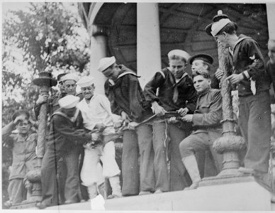 Soldiers and sailors tearing up a flag carried by Socialists during their peace demonstration in Boston - NARA - 533641