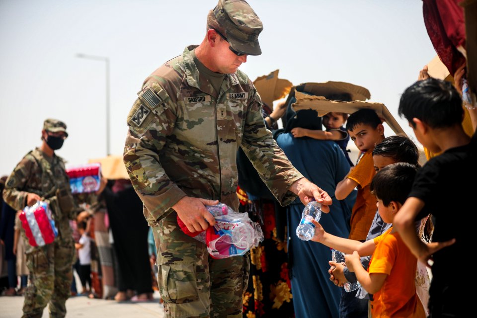 Soldiers assist with the evacuation at Hamid Karzai International Airport 210821-D-D0477-003