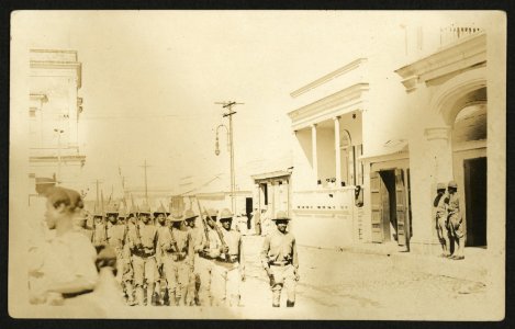 Soldiers marching down street carrying Springfield rifles LCCN2010651601