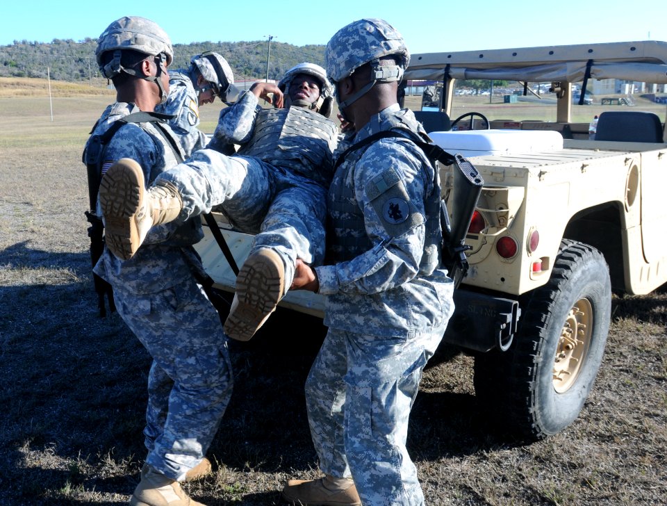 Soldiers from the 525th Military Police Battalion load an injured comrade into a tactical vehicle DVIDS362949