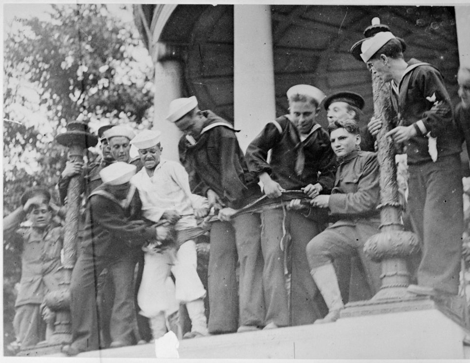 Soldiers and sailors tearing up a flag carried by Socialists during their peace demonstration in Boston - NARA - 533641