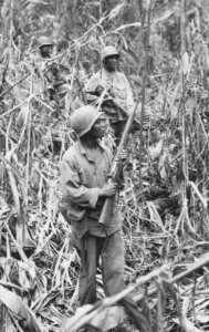 Soldiers of the 93rd Infantry Division (United States) Cautiously advancing through the jungle, while on patrol in Japanese territory off the Numa-Numa Trail - NARA - 531184 (cropped)