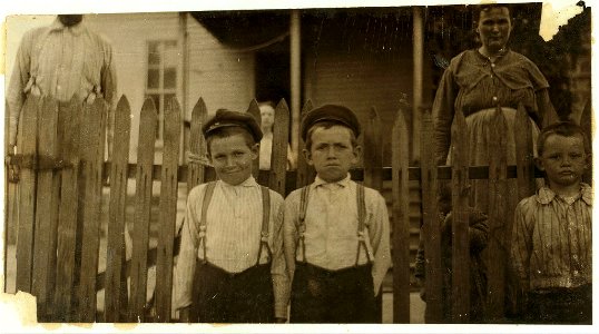 Some of the youngest workers in Laurel Cotton Mills, Miss. Tallest man is Mr. Hollingworth. Two of his boys in front row. Sylvester, ten years old, 'Only helps in the mill afternoons and LOC nclc.02032