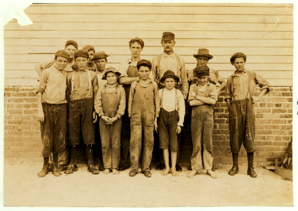 Some of the young workers in Laurel Cotton Mills, Laurel, Miss. Tallest man is Mr. Hollingsworth. Two of his boys in front row. Sylvester, ten years old, 'Only helps in the mill afternoons LOC cph.3c07334