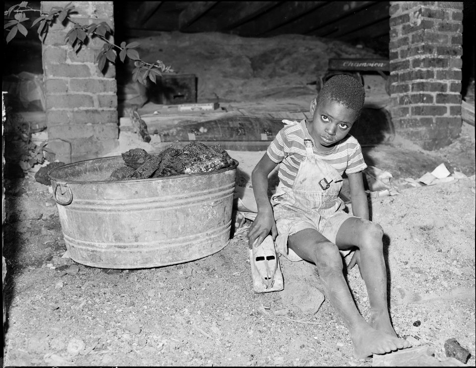 Son of miner playing under his house. He lives in company housing project. Mullens Smokless Coal Company, Mullens... - NARA - 540931