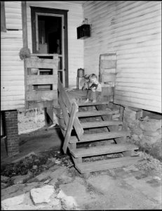 Son of Milong Bond, tipple worker, on the back porch of the family's three room house. Protective railing on the... - NARA - 540963