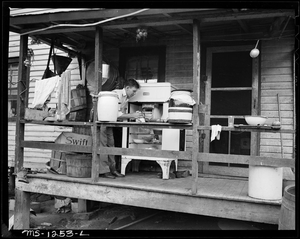 Son, a miner, of Mrs. Judy Lester on back porch of six room house, which rents for $11 monthly, in which Mr. and Mrs.... - NARA - 540754