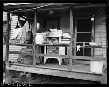 Son, a miner, of Mrs. Judy Lester on back porch of six room house, which rents for $11 monthly, in which Mr. and Mrs.... - NARA - 540754